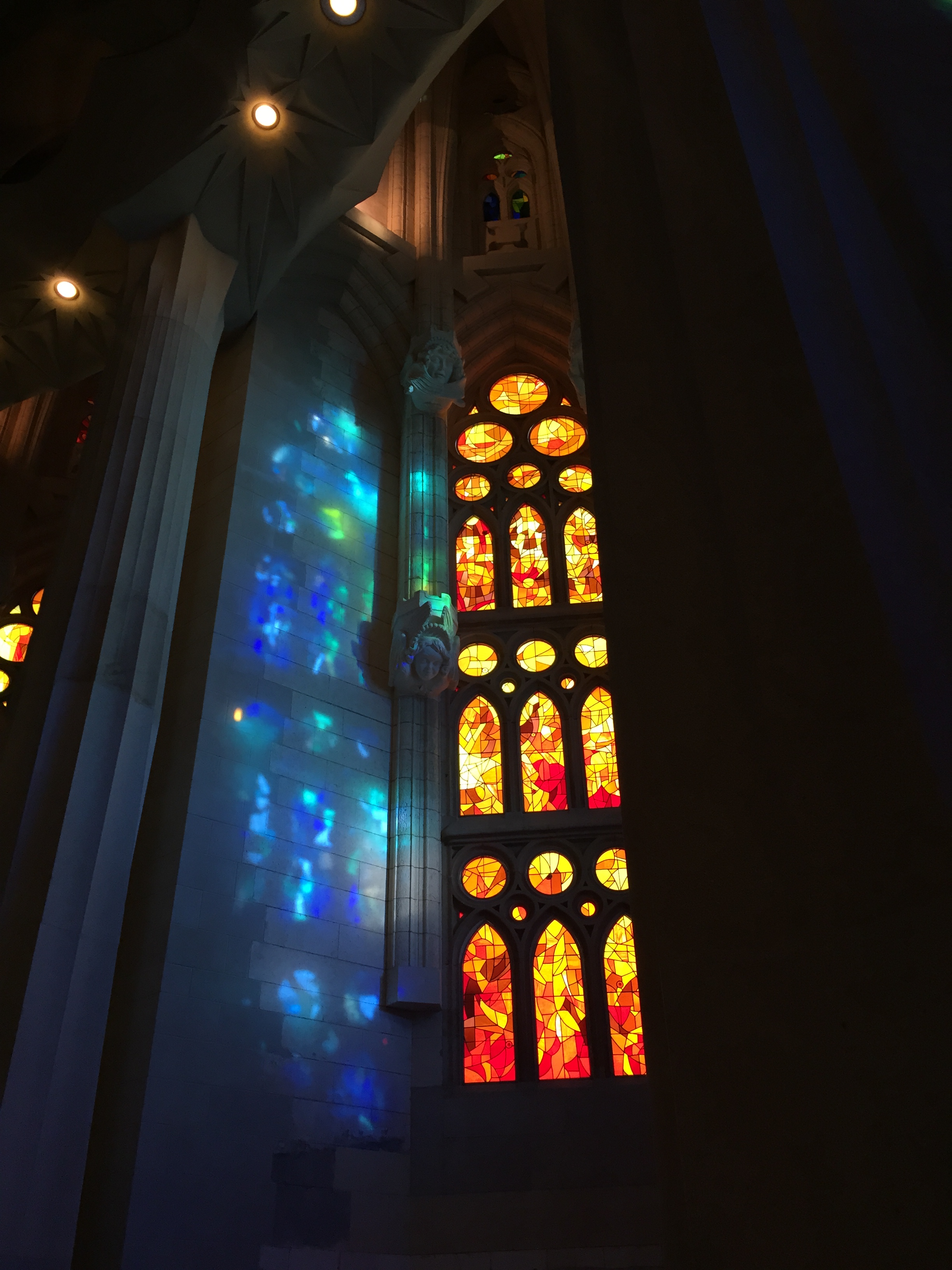 身廊 暖色ステンドグラスの光が柱越しに投影される様子